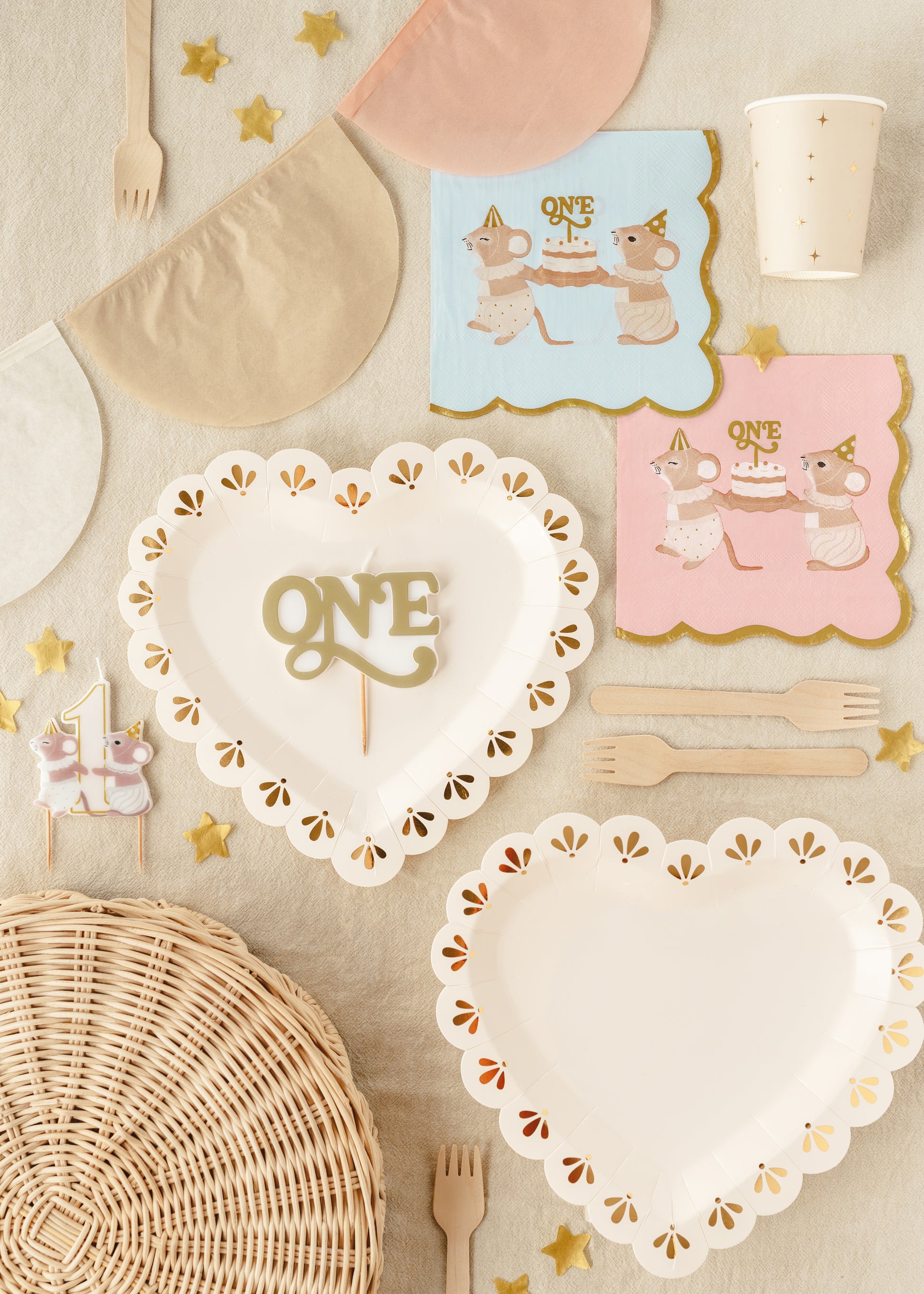 Gold “ONE” birthday candle styled with first birthday tableware available at our Toronto party shop