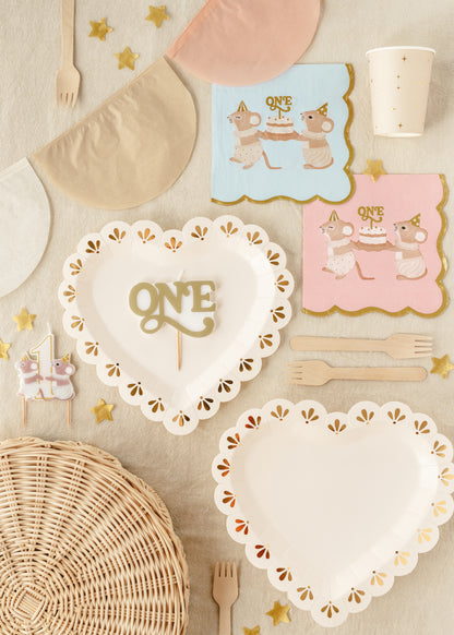 Gold “ONE” birthday candle styled with first birthday tableware available at our Toronto party shop
