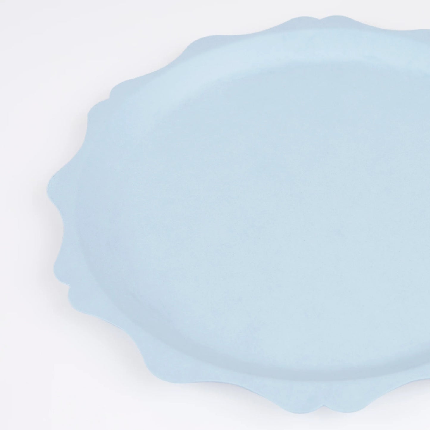 close up of pale blue scalloped side plate with decorative egde