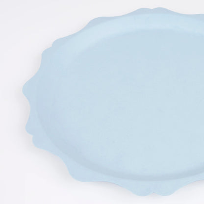 close up of pale blue scalloped side plate with decorative egde