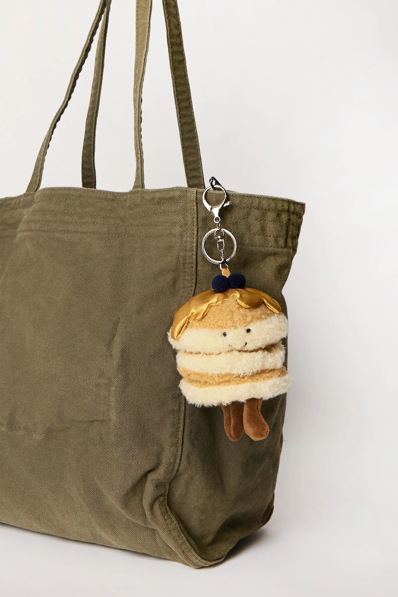 Pancake plush keychain charm clipped onto tote bag available in Toronto and shipping across Canada