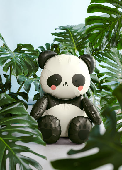 Panda foil balloon styled in a jungle-themed setup with green tropical leaves, available at our Toronto party shop.