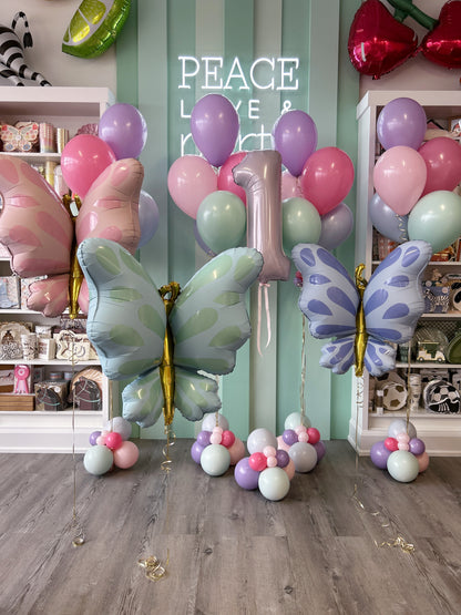 Oversized pastel butterfly balloons in pink, mint and purple with coordinating birthday balloons and a foil number 1.