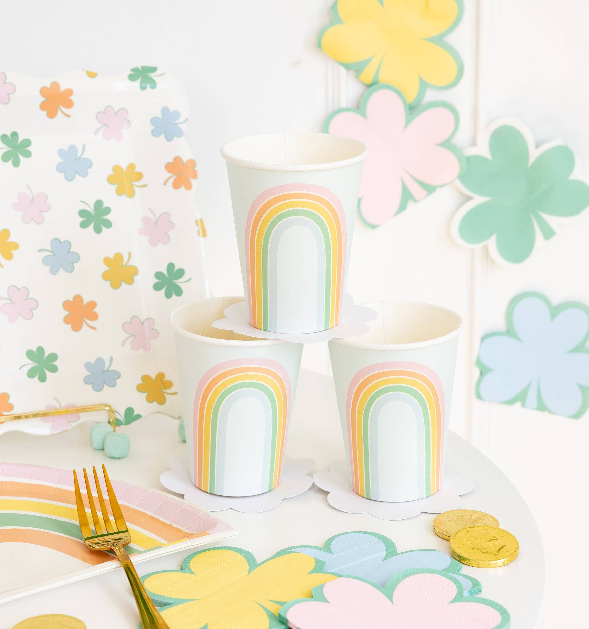 Pastel rainbow paper cups styled on a spring party table with coordinating pastel décor and tableware