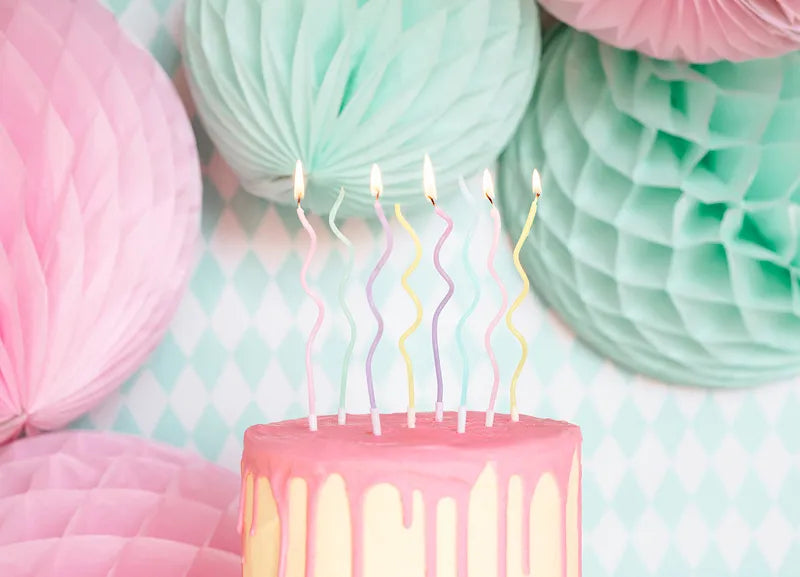 pastel coloured swirly birthday candles on cake