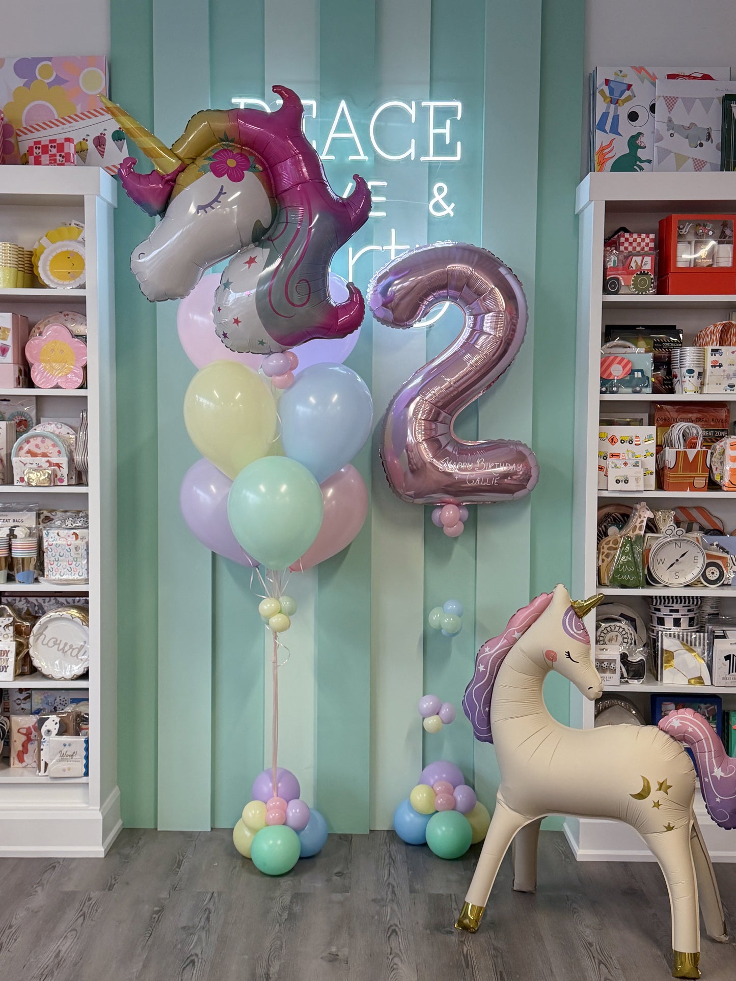 Pastel unicorn birthday balloon bundle with personalized rose gold number, unicorn foil balloons and pastel balloons in Toronto.
