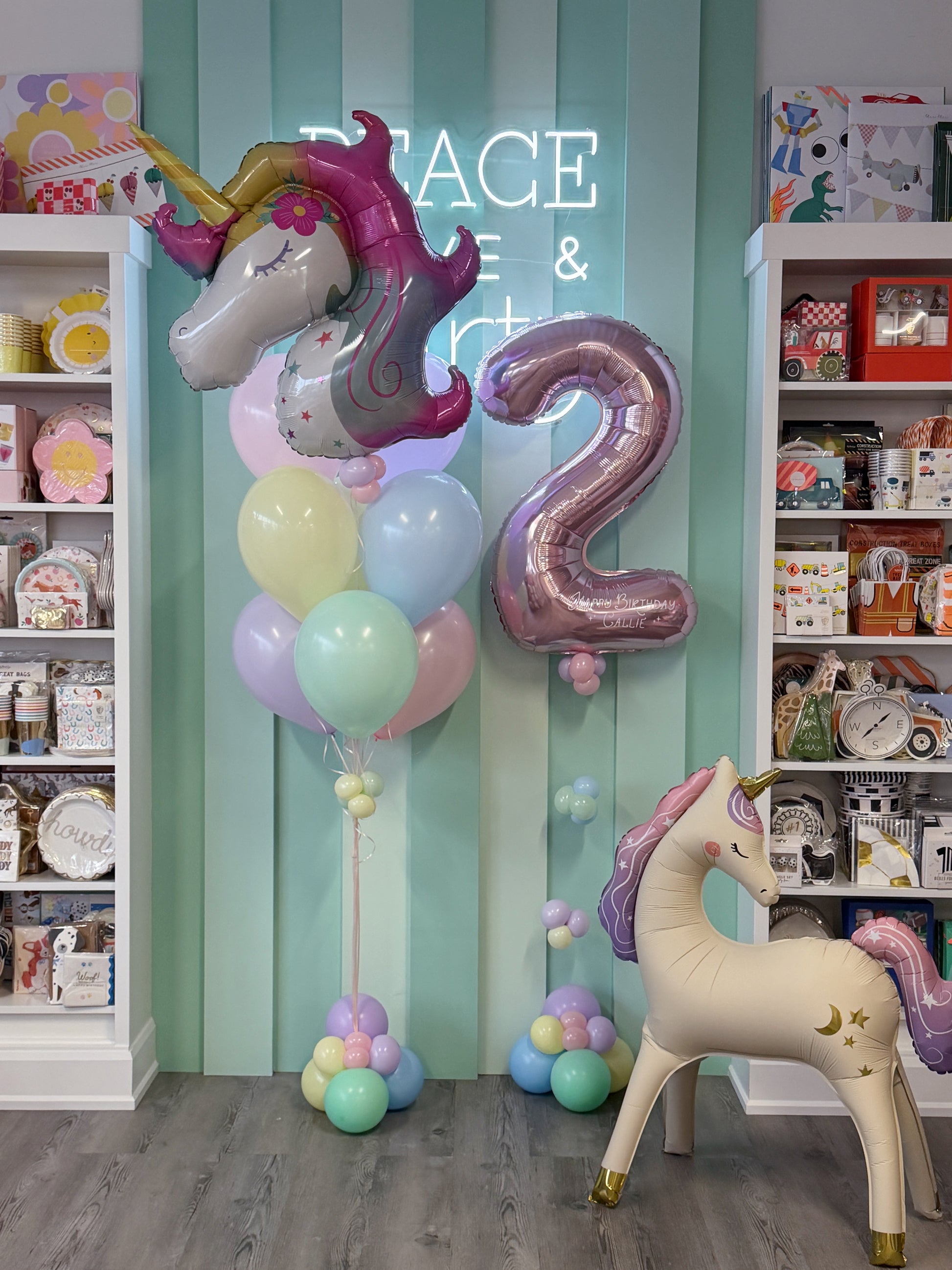 Pastel unicorn birthday balloon bundle with personalized rose gold number, unicorn foil balloons and pastel balloons in Toronto.
