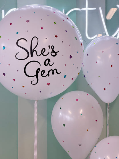 Personalized “She’s a Gem” jumbo balloon with colourful rhinestone and gem details, paired with coordinating bedazzled balloons in Toronto.