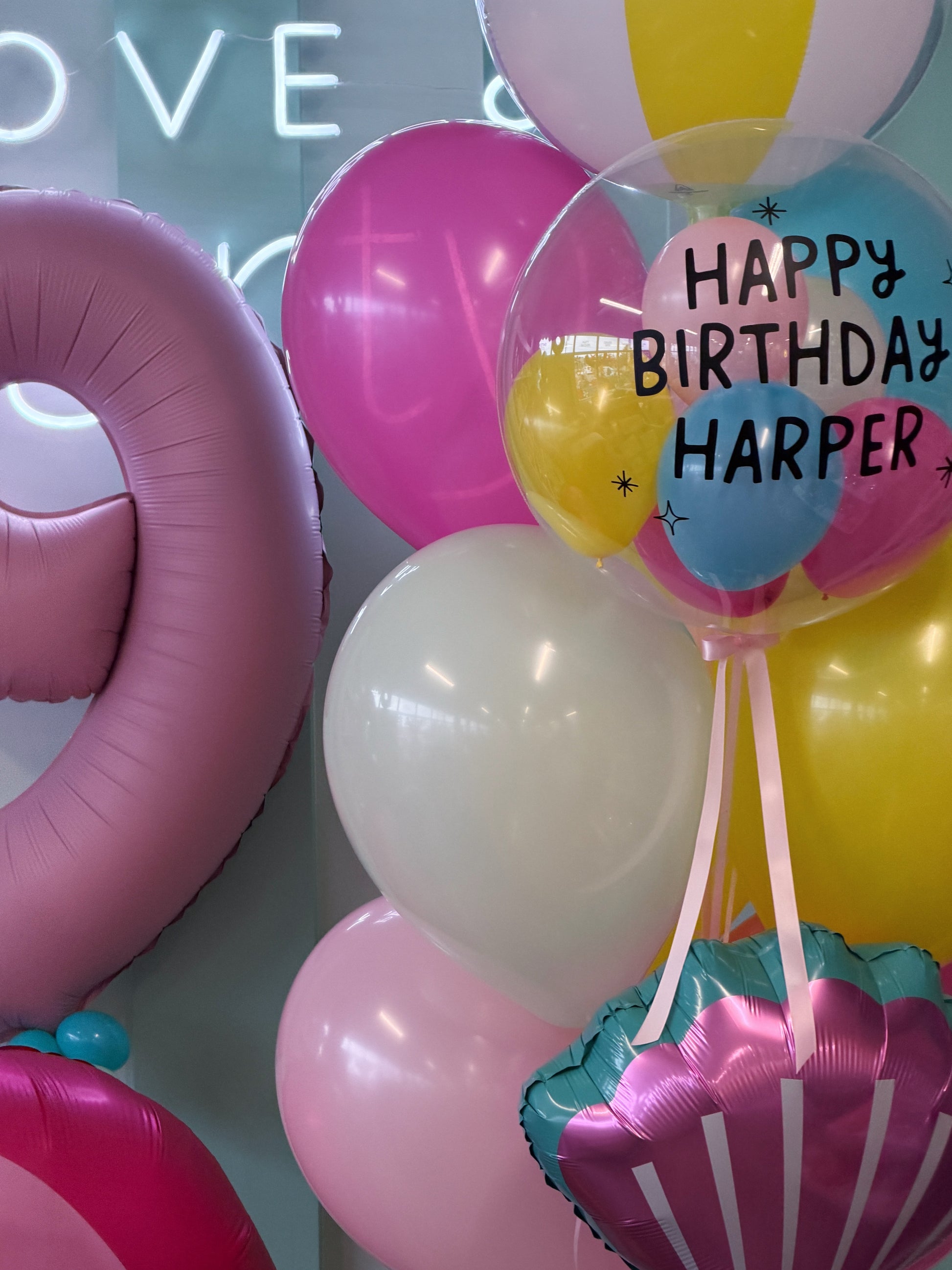Personalized pool party balloon bouquet with bubble balloon, beach ball, seashell and pink, yellow, blue and MINT balloons in Toronto.