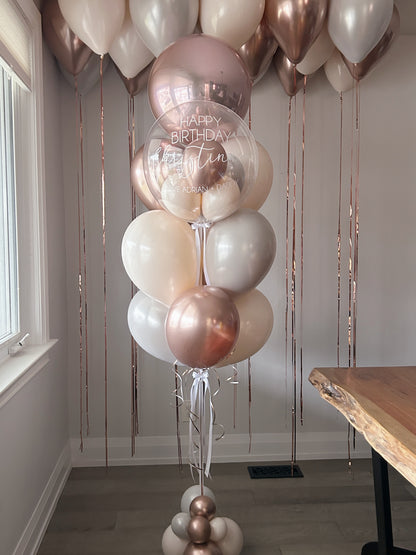 Personalized clear birthday bubble balloon with rose gold, cream and pearl white balloons in Toronto.
