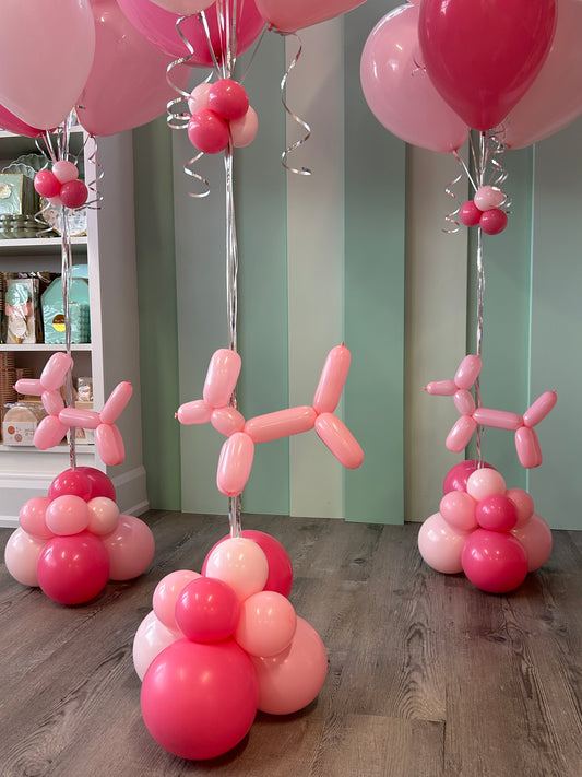 Close-up of pink balloon dog detail attached to a blush and hot pink helium balloon bundle base in Toronto.