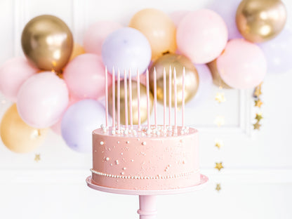 tall pink birthday candles on cake