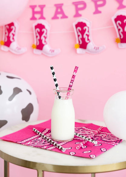 Pink cowgirl straws styled with milk bottle and western décor, Toronto party setup.