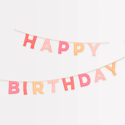 Felt Happy Birthday banner with stitched letters in pink and peach hues