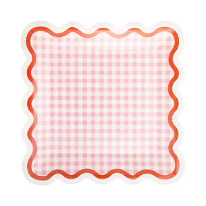 Pink gingham square paper plates with red and cream wavy scalloped edge