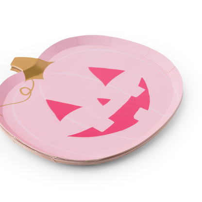 Stack of pink pumpkin Halloween plates with jack-o'-lantern faces and gold foil stems