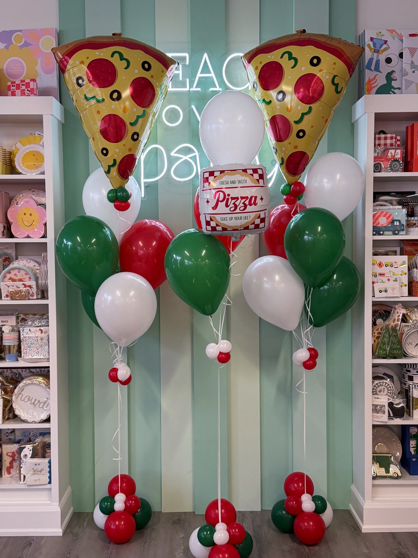 Pizza party balloon bundle with oversized pizza slice balloons and red, green and white balloons for birthday parties in Toronto.