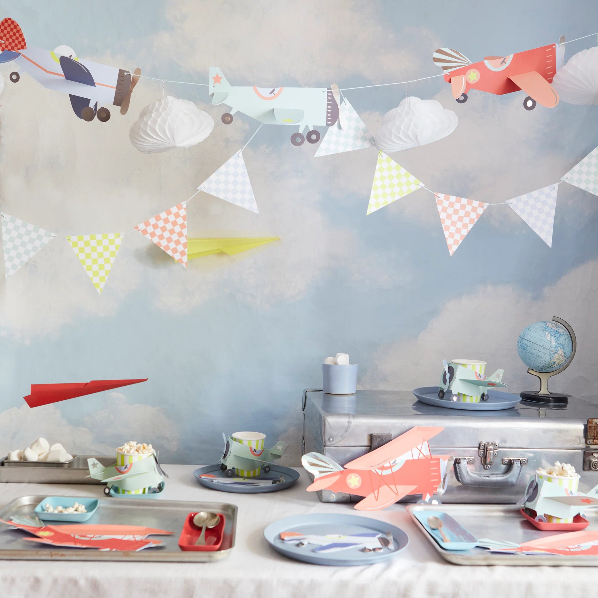 Aviation birthday party setup featuring Meri Meri planes garland with coordinating tableware, available at our Toronto party shop.