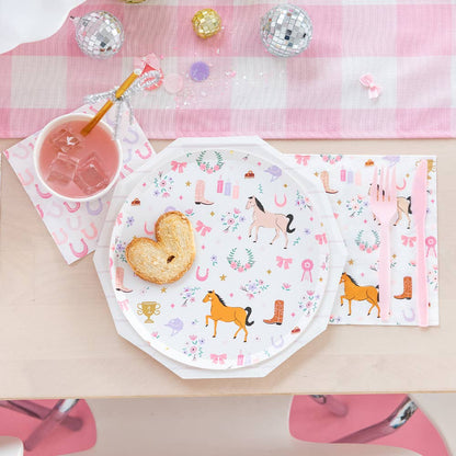 Pony Tales cocktail napkin with horseshoe print styled with horse-themed plates and pink gingham runner for Toronto western parties.