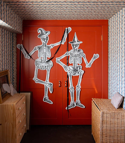 Large paper skeletons styled as Halloween wall and door decorations