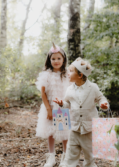 kids holding unicorn and castle gift bags 