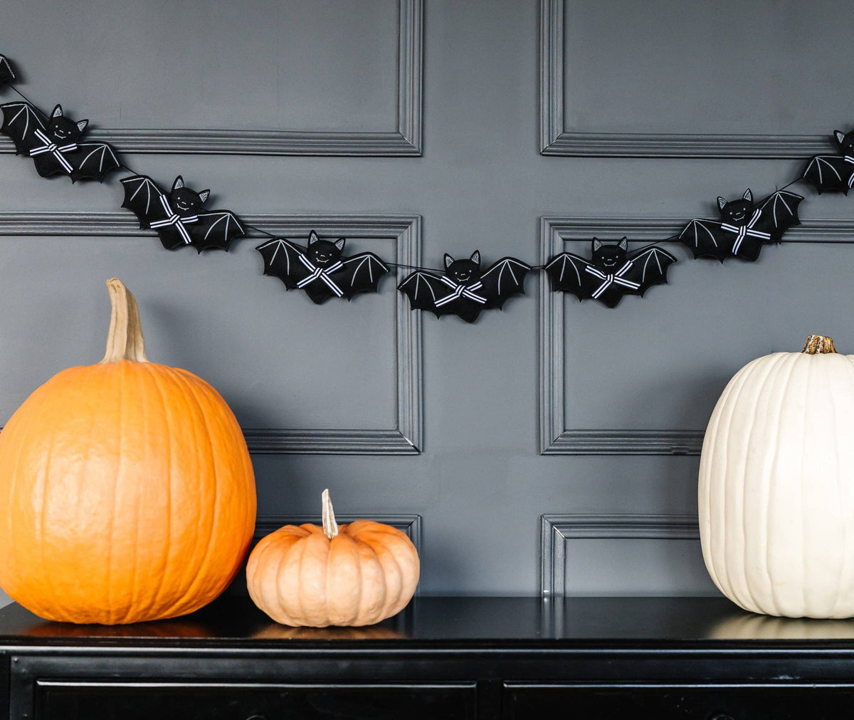 Black felt bat and bow banner styled with pumpkins for Halloween
