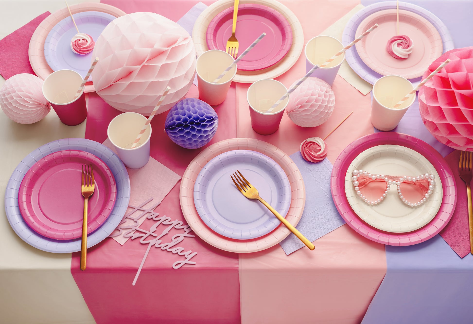 Pink and purple party table with layered table cover and pastel tableware available at our Toronto party shop