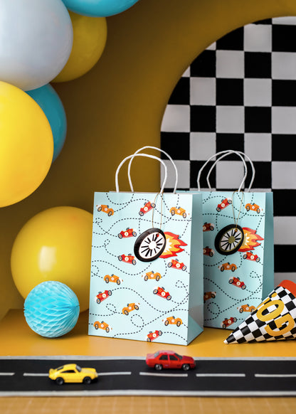 Race car party gift bags styled with balloons and décor, sold in Toronto at Confetti My Party. Ships across Canada.