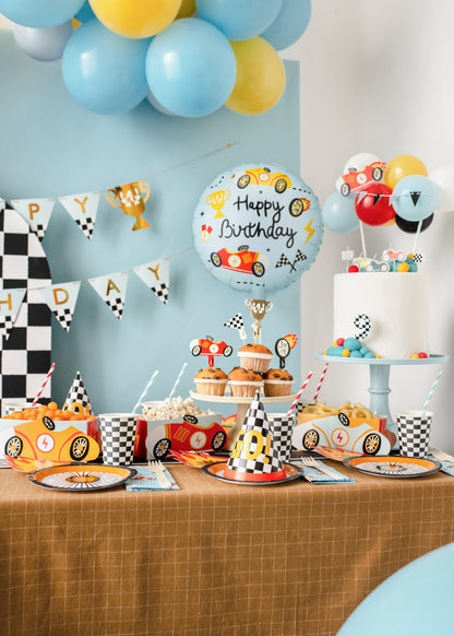Race car Happy Birthday foil balloon styled beside matching racing party tableware available at our Toronto party shop