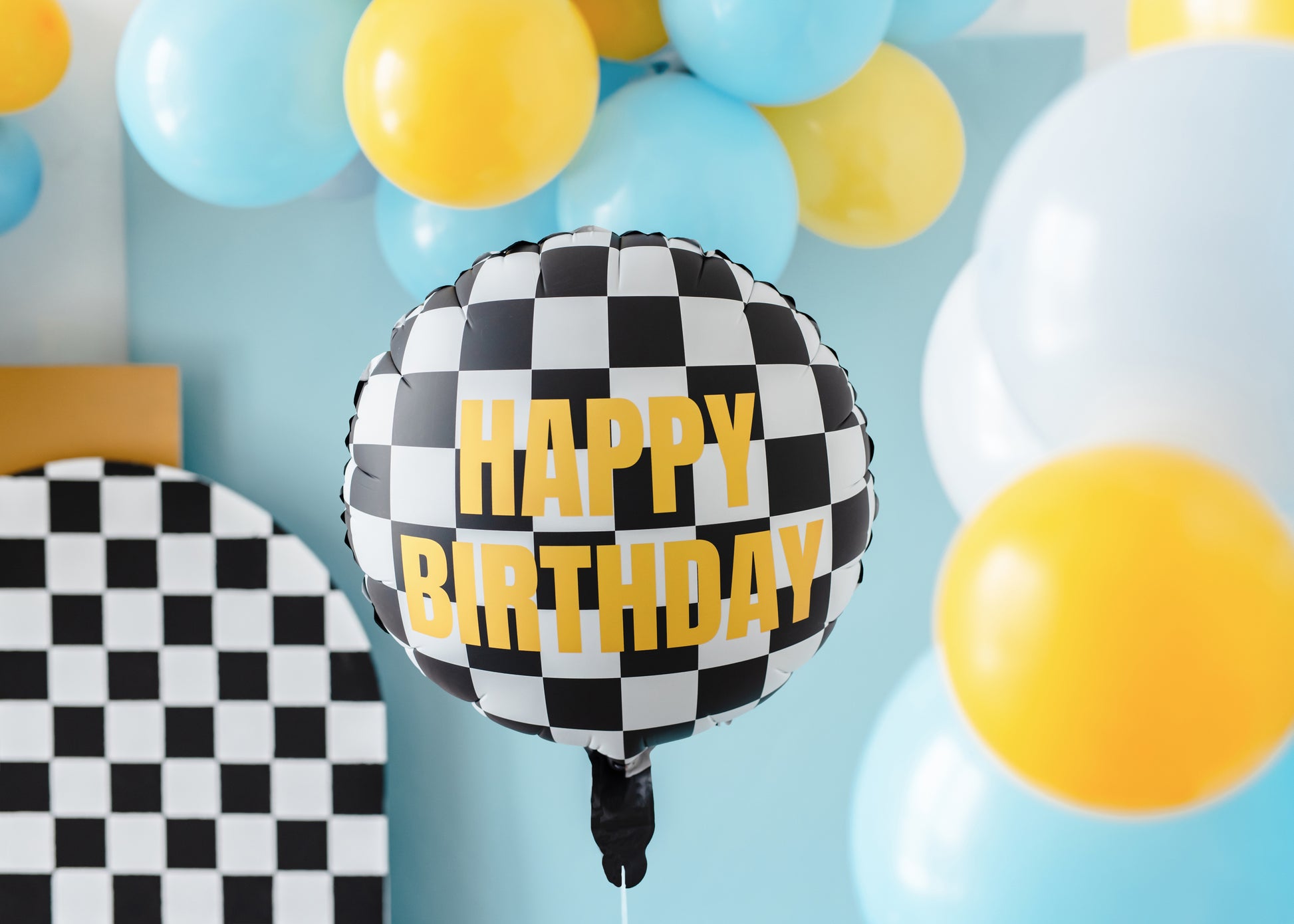 Race-car themed checkered Happy Birthday balloon styled with colourful latex balloons, sold in Toronto at Confetti My Party. Ships across Canada.
