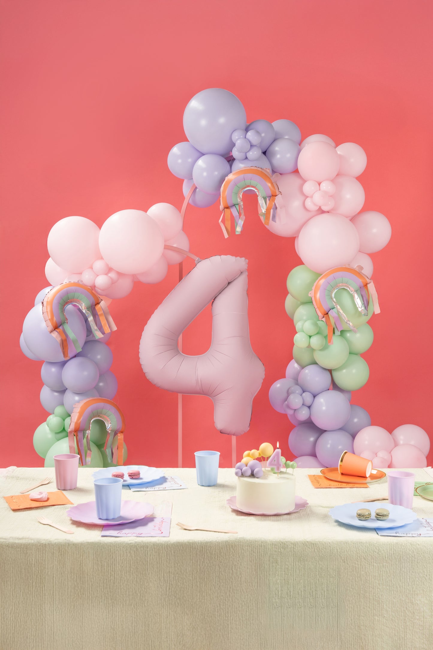 Rainbow foil balloon with fringe styled in a balloon garland with matching party decor - sold in Toronto at Confetti My Party.