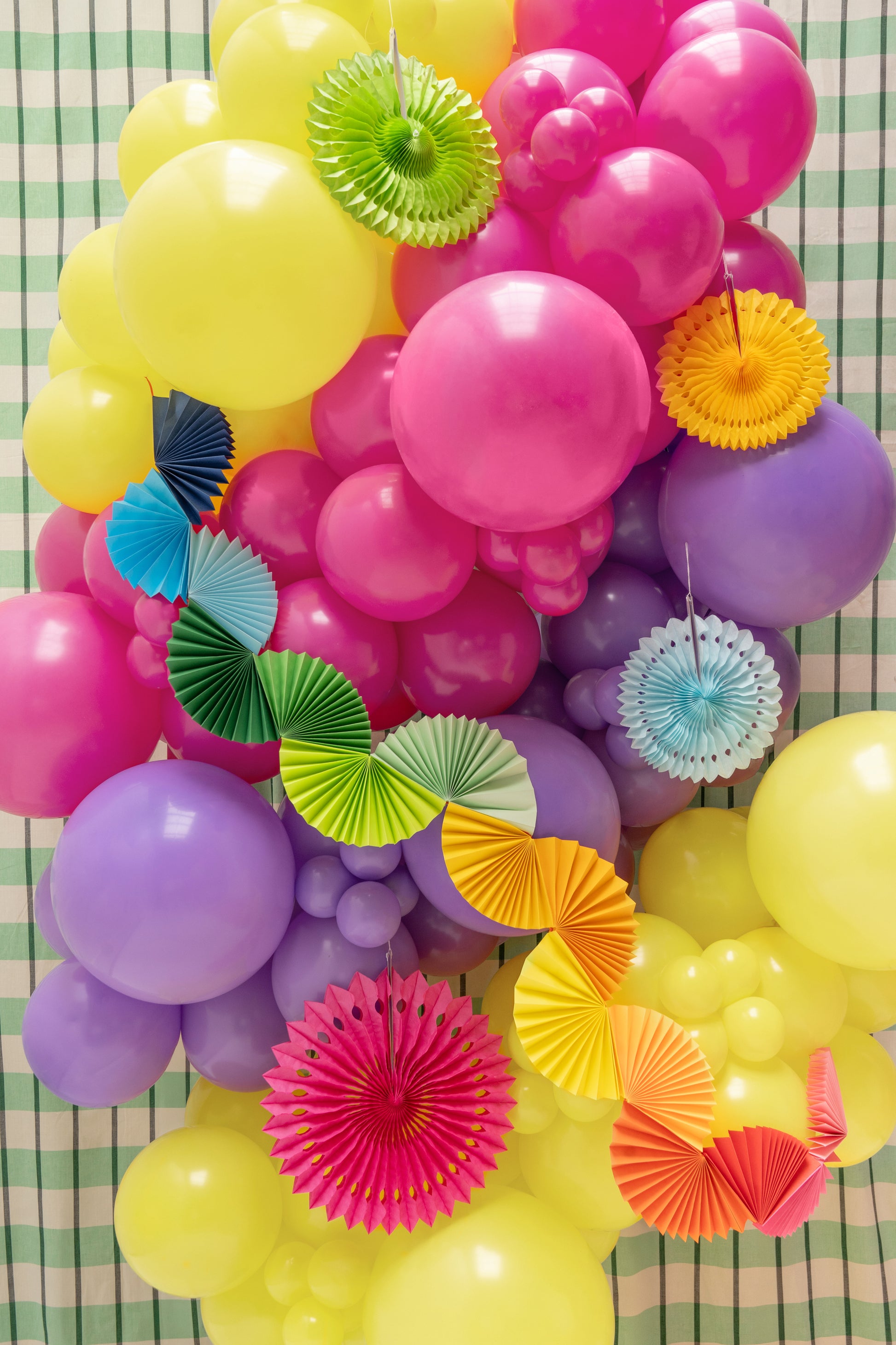 Paper garland featuring folded rainbow fan shapes in a mix of bright colours, approx. 8 ft long.