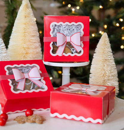 Festive Toronto display featuring red and pink cookie boxes with bows and bottle brush trees.