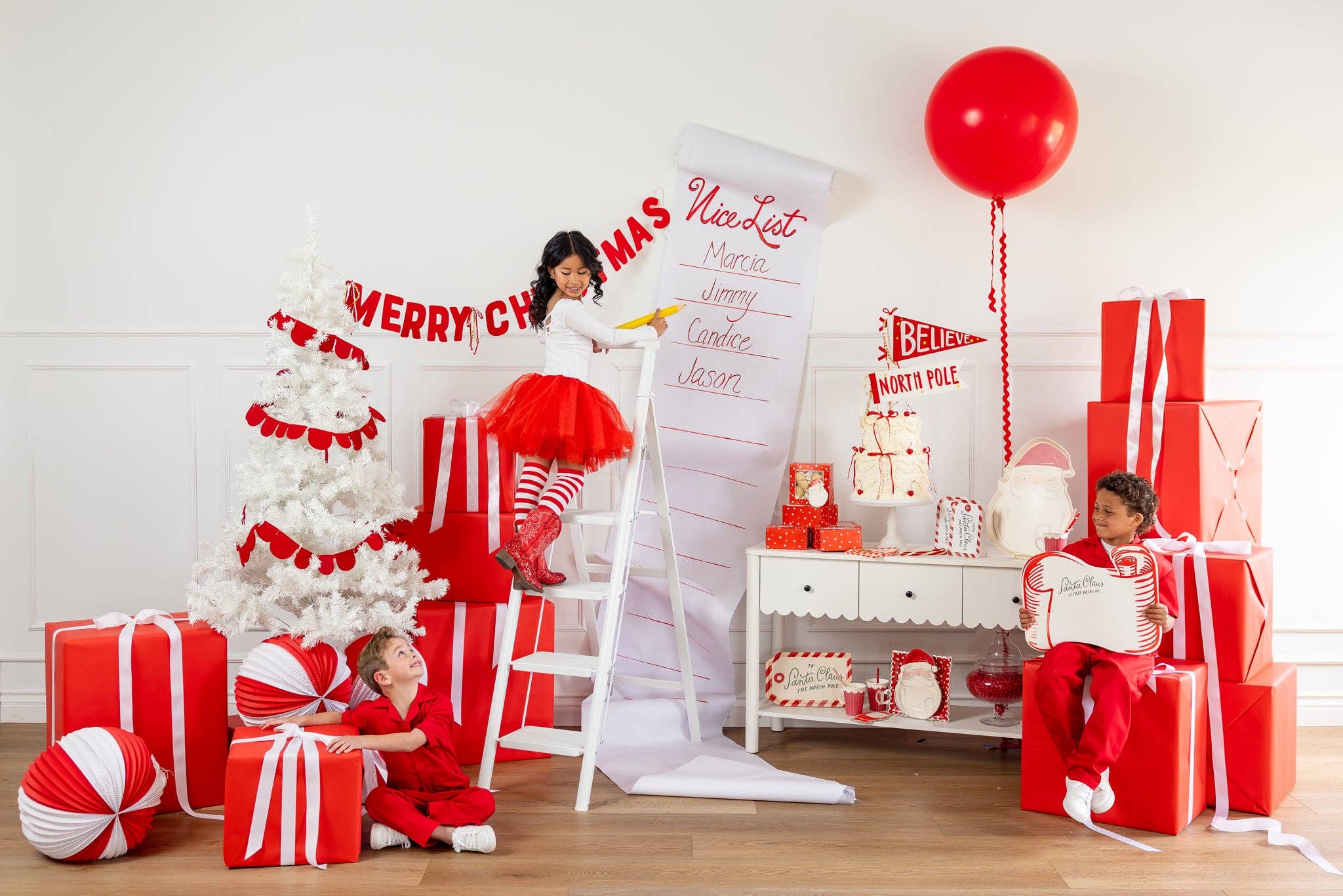 Kids’ holiday party setup in red and white with Santa scroll placemat and Christmas decor, Toronto party inspiration.