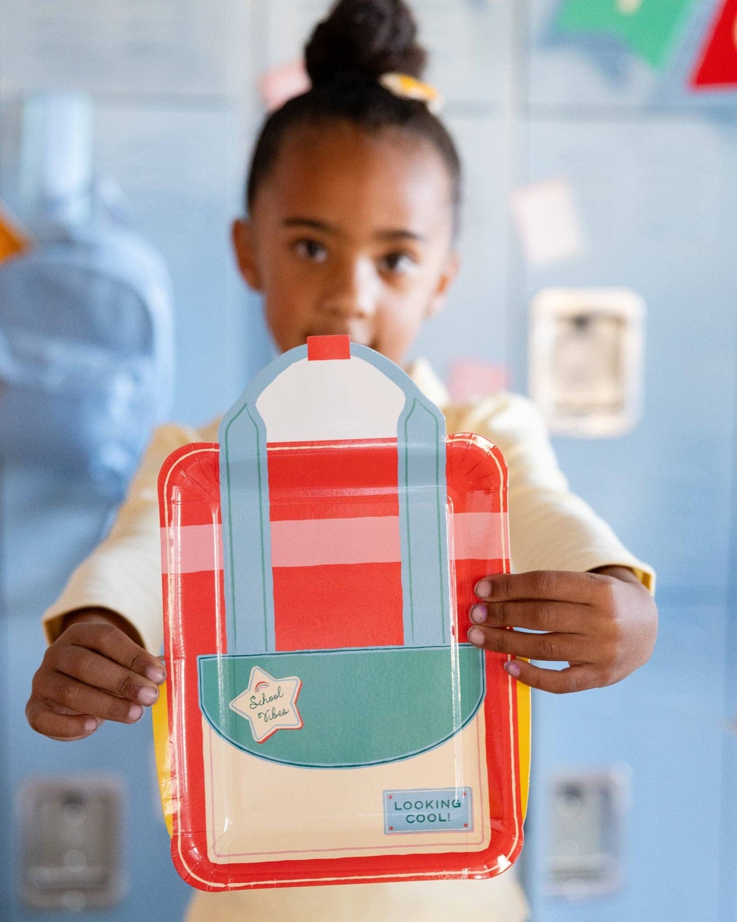 Back to school party table featuring backpack shaped paper plates and colourful school-themed decorations available at our Toronto party shop.