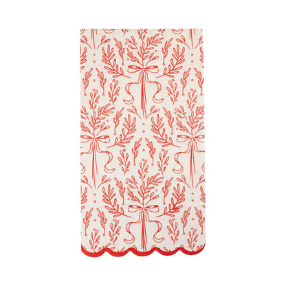 White scalloped paper dinner napkin with red bough and ribbon design, perfect for festive Toronto holiday tables.