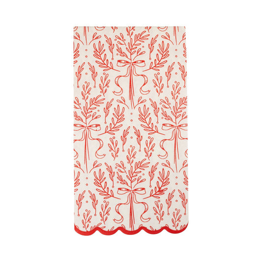 White scalloped paper dinner napkin with red bough and ribbon design, perfect for festive Toronto holiday tables.