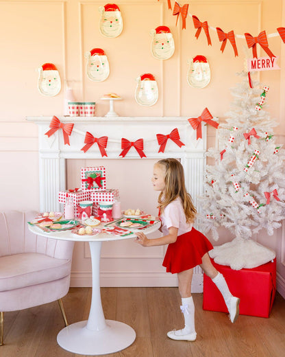 Christmas dessert table with red bow banner, checkered plates and wrapped gifts, Toronto party inspiration.