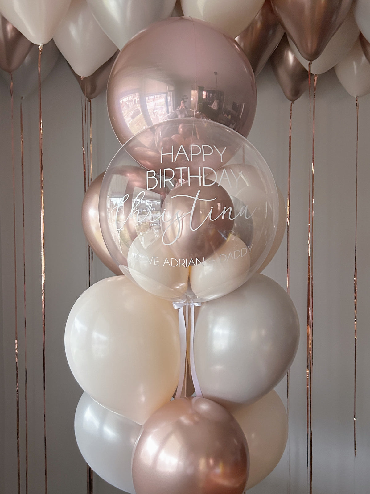 Rose gold and cream personalized birthday balloon package with clear stuffed bubble balloon in Toronto.