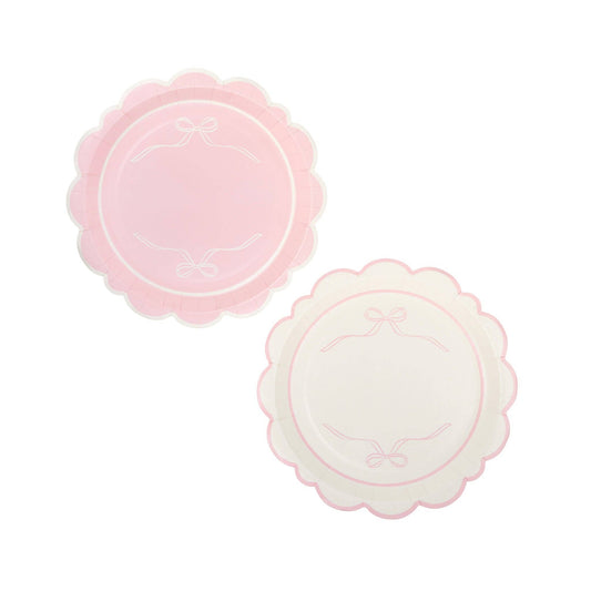 Round scalloped paper plates in pink with delicate bow detail, sold in Toronto at Confetti My Party