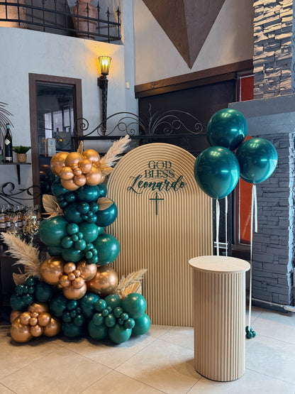 Sacrament event backdrop with emerald green and gold balloon garland and plinth display available at our Toronto party shop