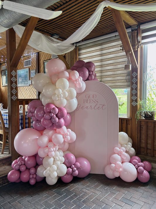 Pink sacrament backdrop with custom name sign and balloon garland available for delivery in the GTA