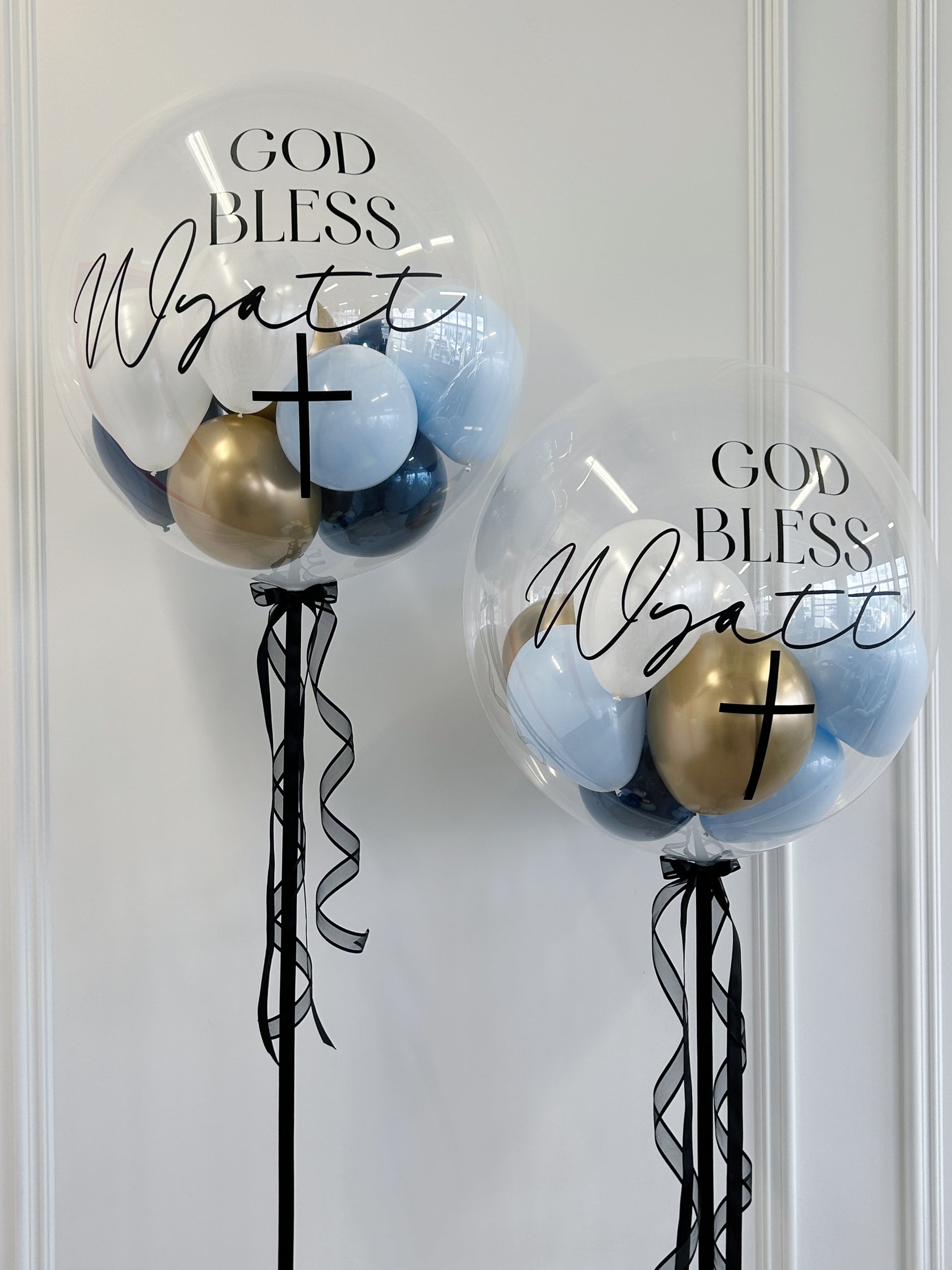 Personalized sacrament bubble balloons with blue, gold and white balloons available at our Toronto party shop