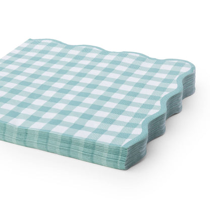 A stack of square paper napkins with a light sage and white gingham check pattern and scalloped edges, shown on a clean white background.