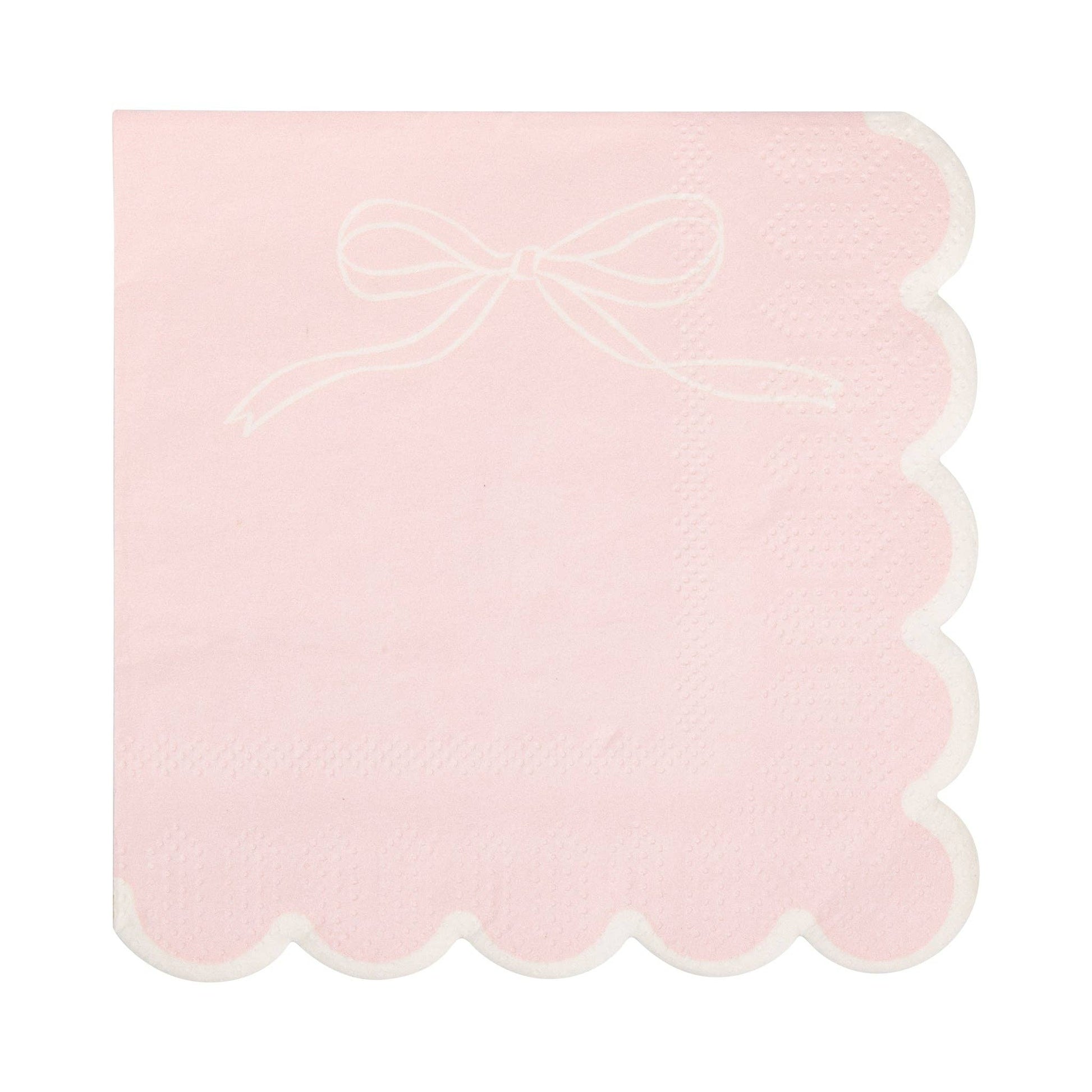 Blush pink cocktail napkin with a subtle white bow design and scalloped edges, available in Toronto at Confetti My Party.