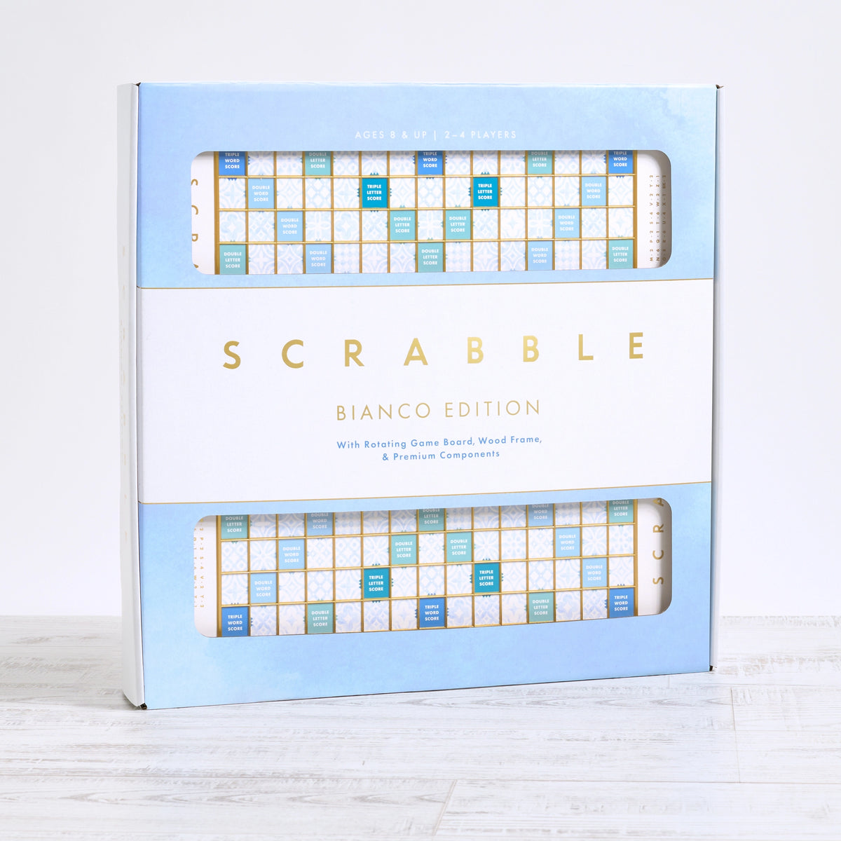 Scrabble Bianco Edition board game featuring a rotating wooden board and blue, white + gold details. Pick up in Toronto + Canada-wide shipping available.