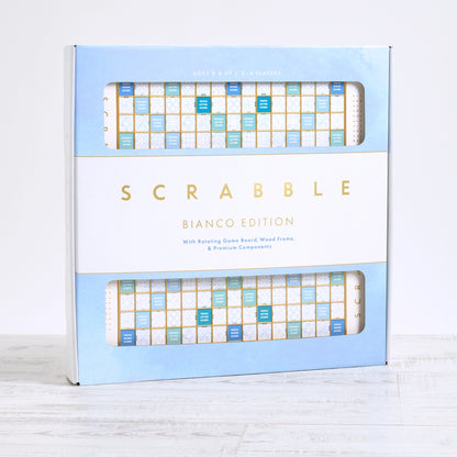 Scrabble Bianco Edition board game featuring a rotating wooden board and blue, white + gold details. Pick up in Toronto + Canada-wide shipping available.