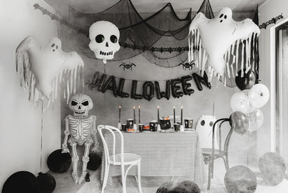 Halloween-themed room with decorations including ghosts, a skeleton, and balloons sold in Toronto at Confetti My Party.