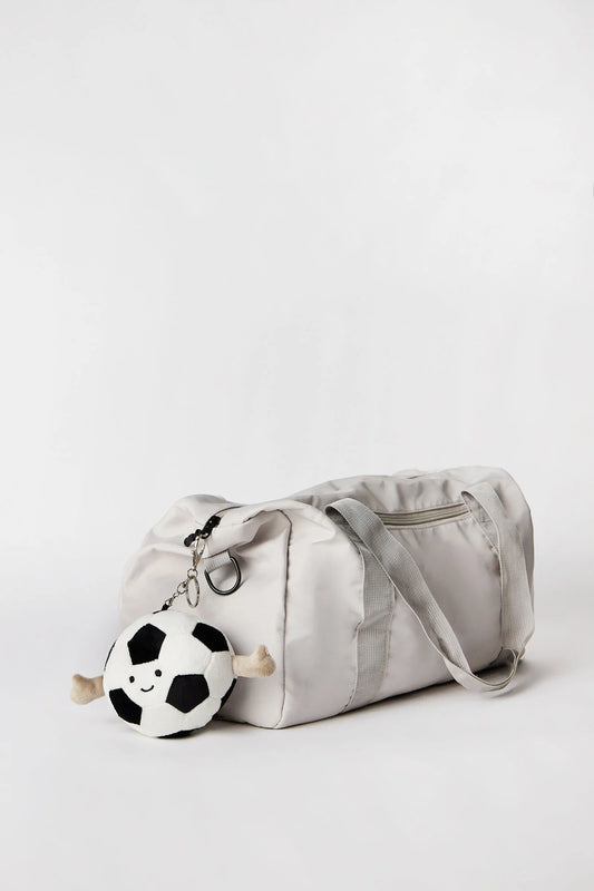 Soccer ball plush keychain charm clipped onto bag available in Toronto and shipping across Canada