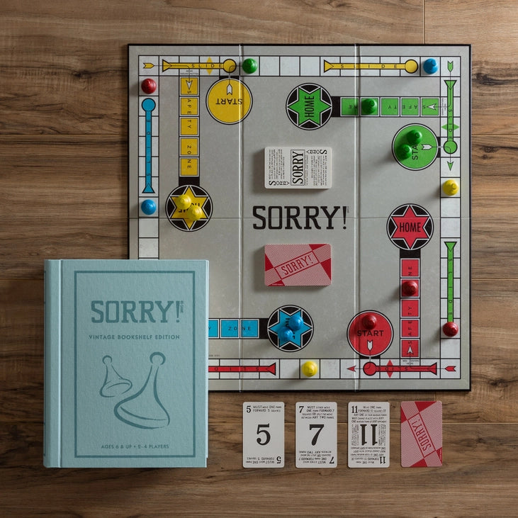 Opened Sorry! bookshelf edition showing pawns, cards, and board, shipping across Canada.